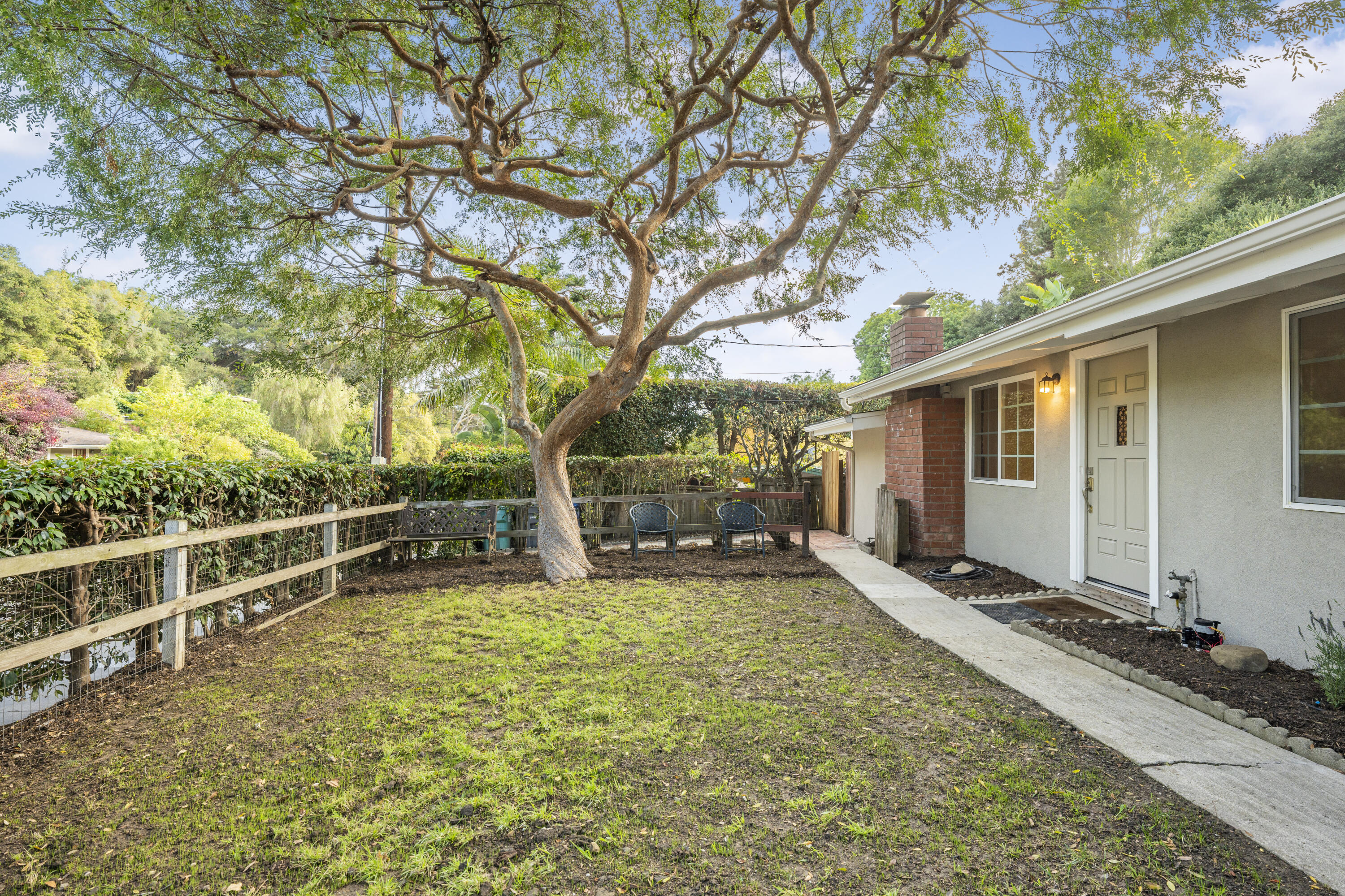 901 Fellowship Road Santa Barbara, CA 93109 - Photo 4 of 44 a view of a house with a large tree and a yard