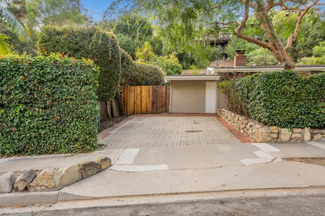 a view of a backyard with table and chairs and wooden fence