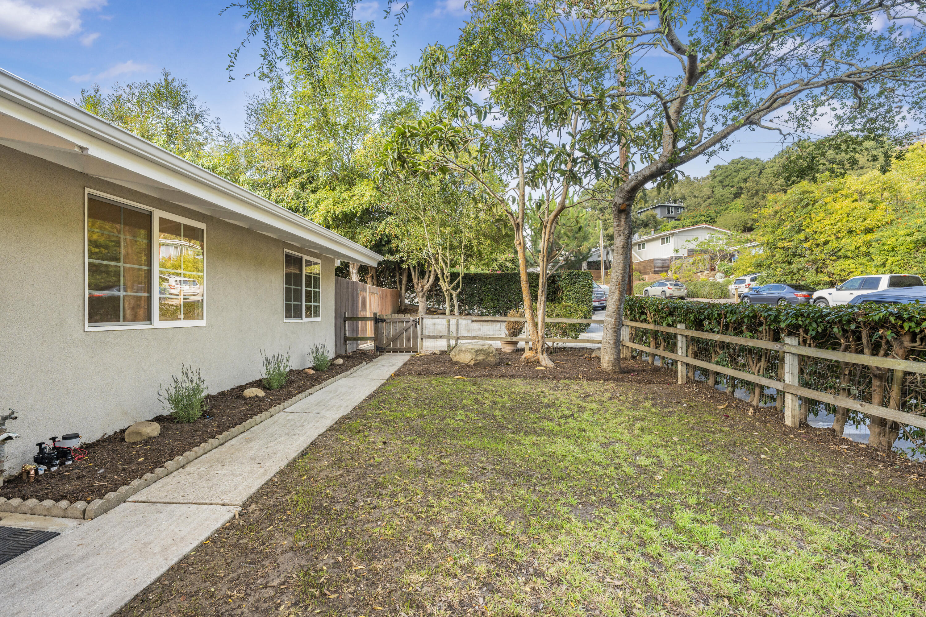901 Fellowship Road Santa Barbara, CA 93109 - Photo 6 of 44 a view of a backyard with table and chairs and wooden fence