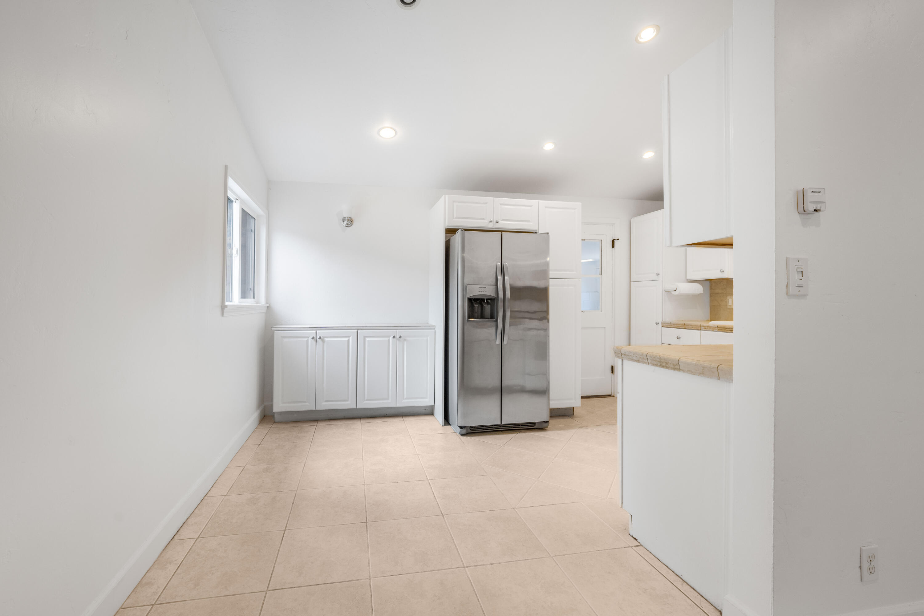 901 Fellowship Road Santa Barbara, CA 93109 - Photo 10 of 44 an empty room with a refrigerator and mirror