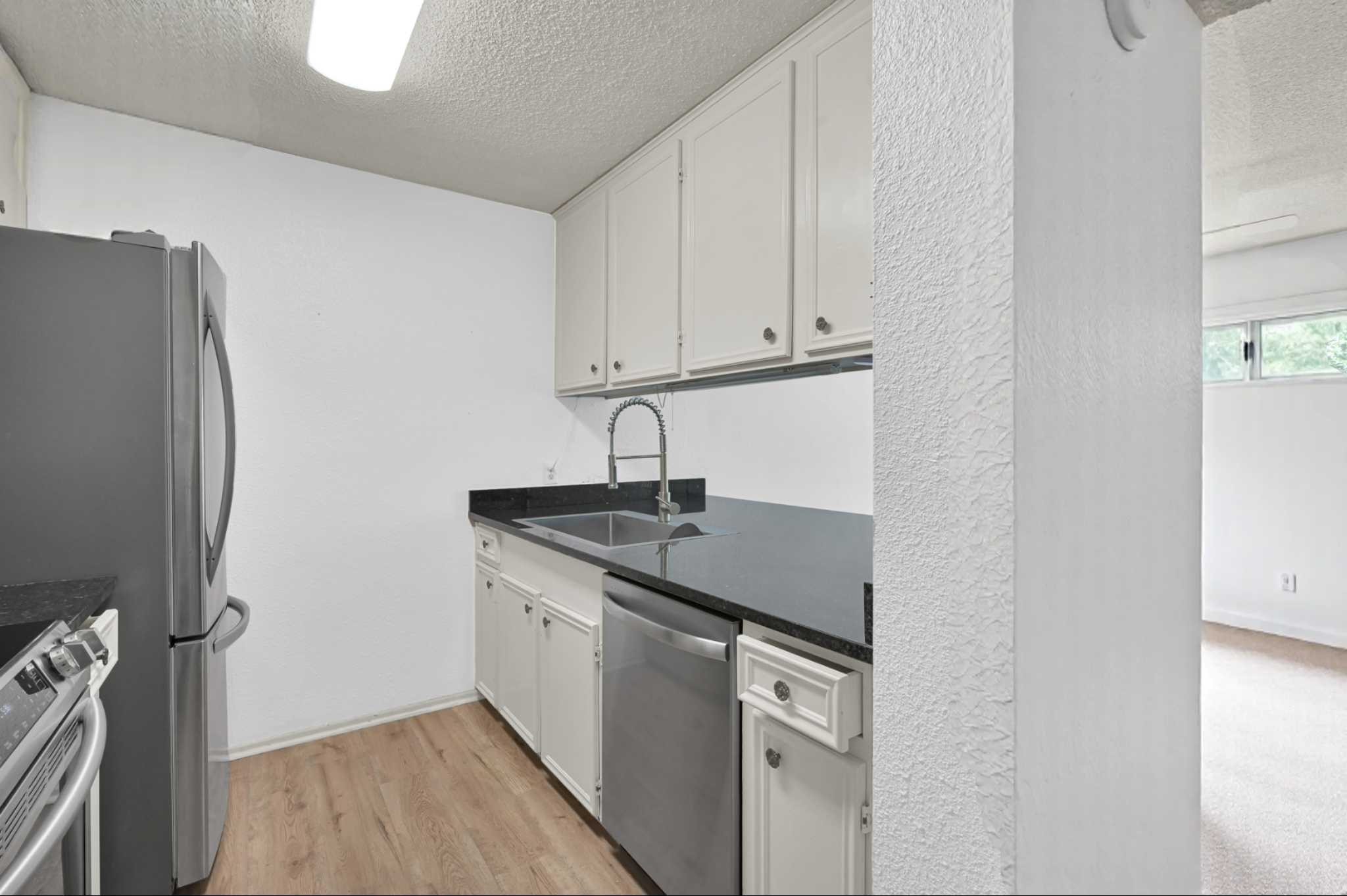 162 Villa Way Coldspring, TX 77331 - Photo 9 of 42 a kitchen with stainless steel appliances granite countertop a sink and a refrigerator