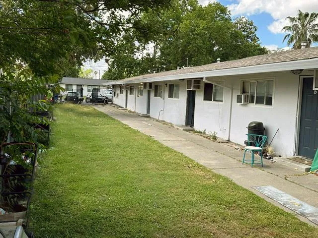 a view of a house with backyard sitting area and garden
