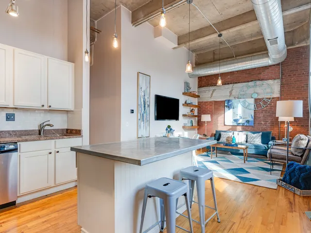 a kitchen with stainless steel appliances granite countertop a sink and cabinets