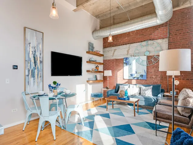 a living room with patio furniture and a flat screen tv