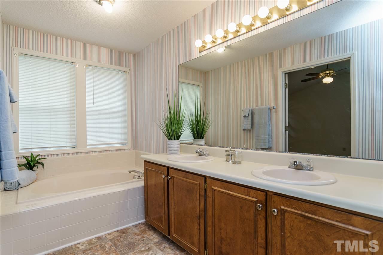2301 Carthage Circle Raleigh, NC 27604 - Photo 11 of 17 a bathroom with a tub a sink and a mirror