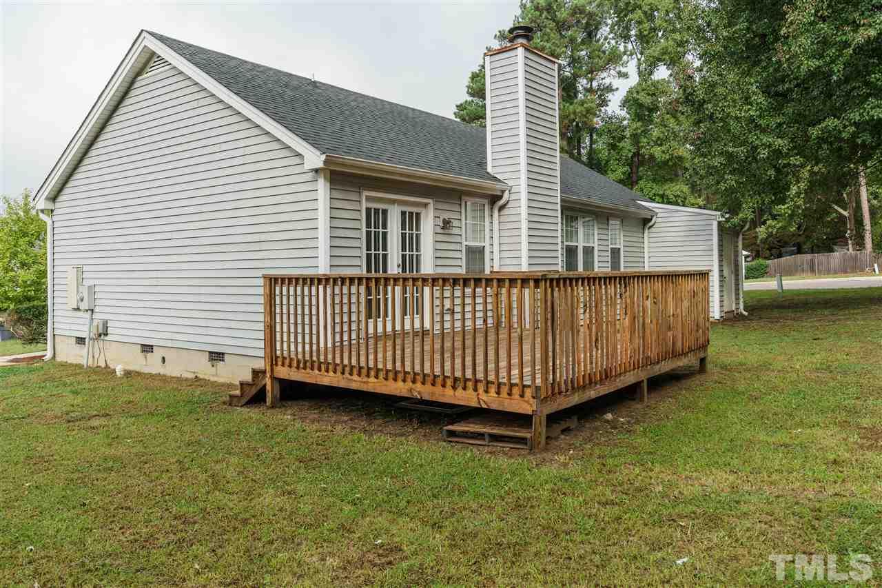 2301 Carthage Circle Raleigh, NC 27604 - Photo 15 of 17 a view of a backyard with a small deck and a garden