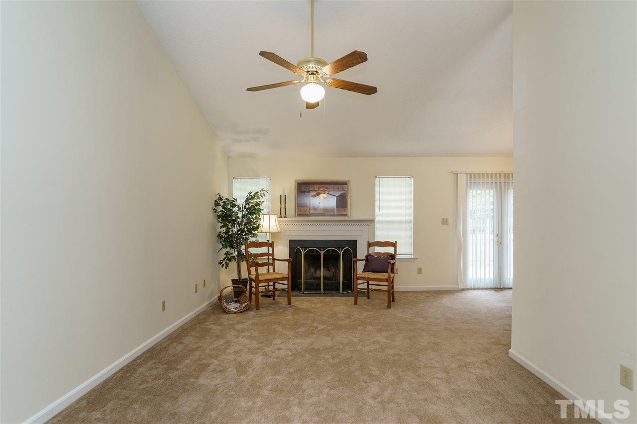 2301 Carthage Circle Raleigh, NC 27604 - Photo 4 of 17 a view of a livingroom with a fireplace and a ceiling fan
