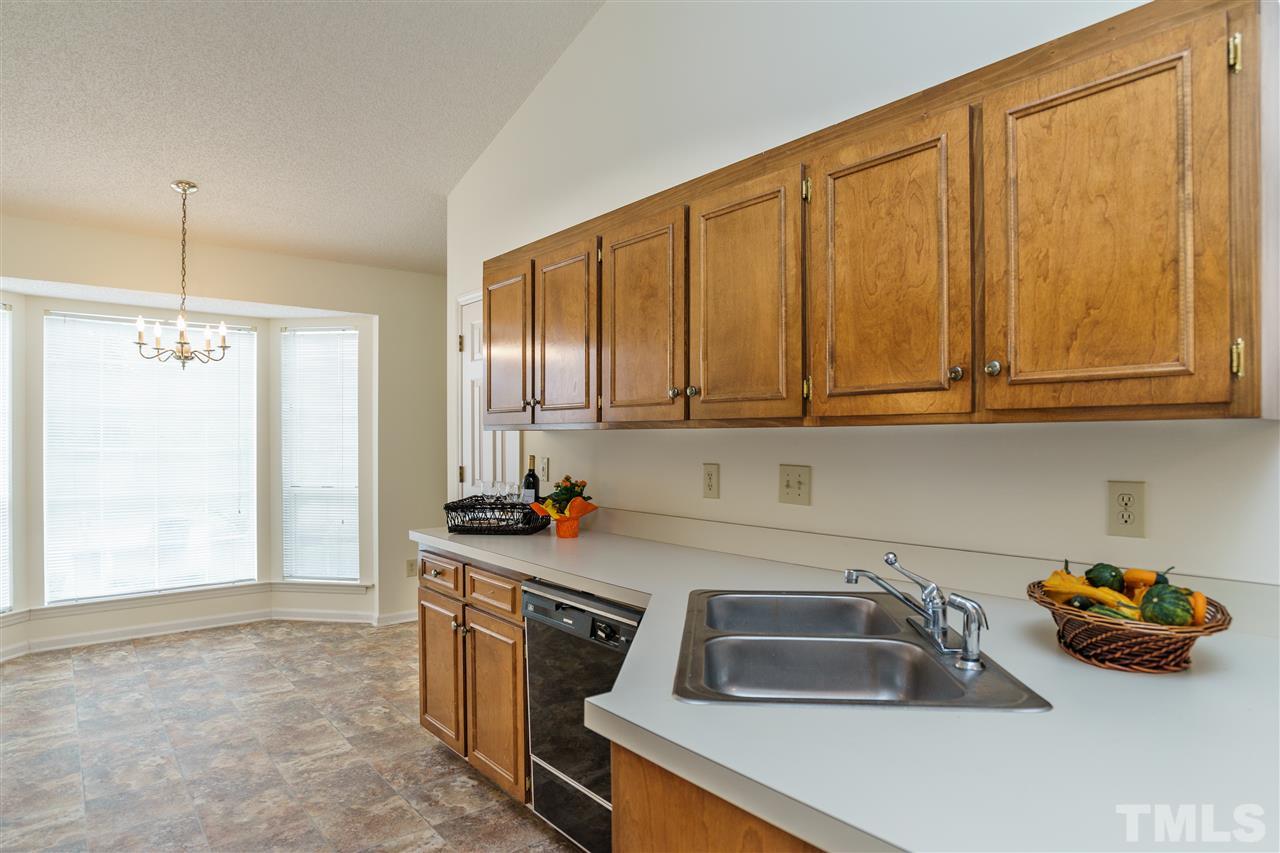 2301 Carthage Circle Raleigh, NC 27604 - Photo 6 of 17 a kitchen with sink cabinets and window