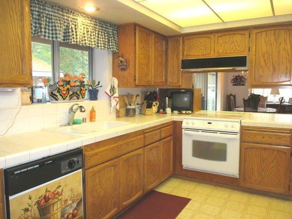 8251 North Applegate Road Grants Pass, OR 97527 - Photo 13 of 35 a kitchen with stainless steel appliances granite countertop a sink and cabinets