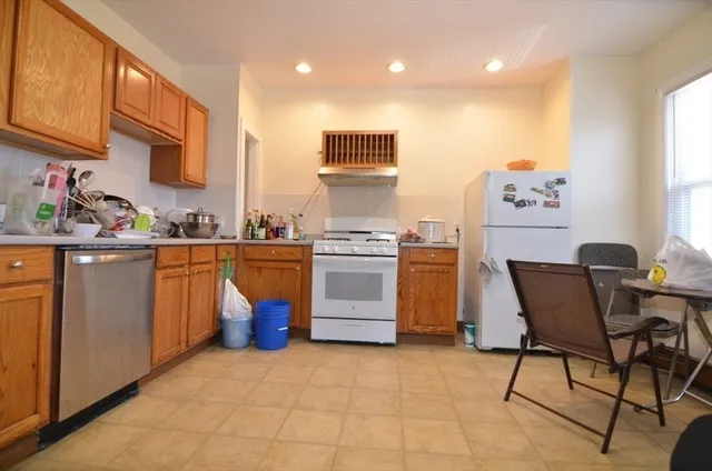 a kitchen with a stove top oven sink and cabinets