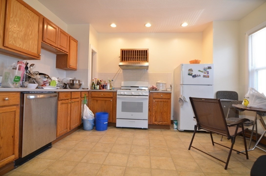 a kitchen with a stove top oven sink and cabinets