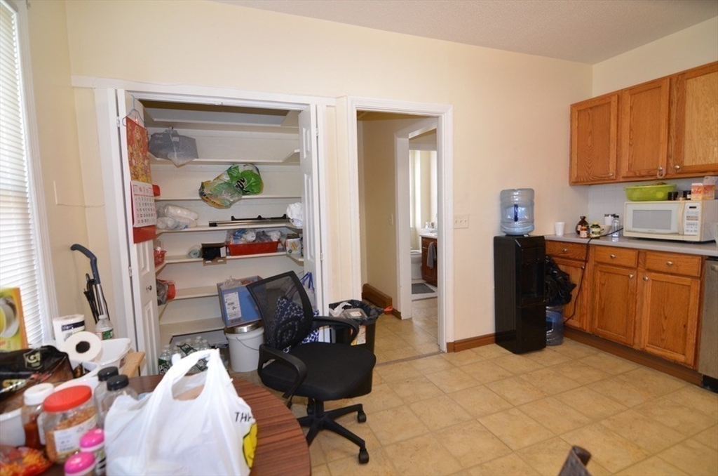 30 Copeland Street, Unit 3 Quincy, MA 02169 - Photo 3 of 17 a view of a workspace with furniture and bedroom