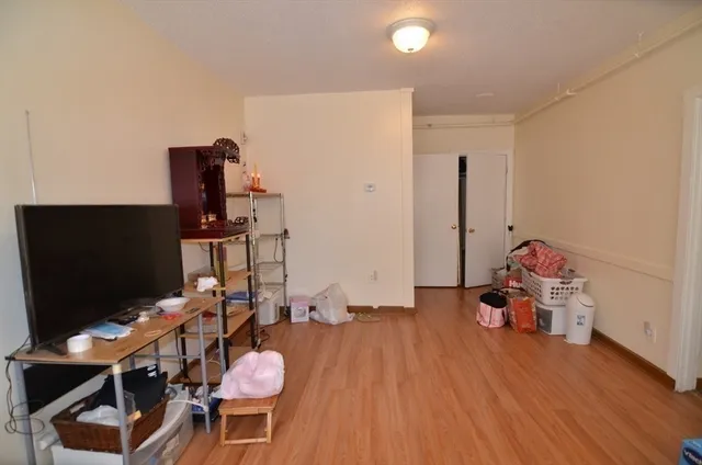 a bedroom with furniture and a flat screen tv
