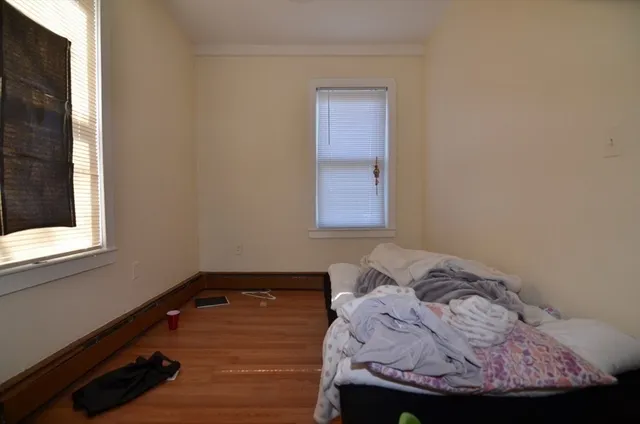 a bed sitting in a bedroom next to a window