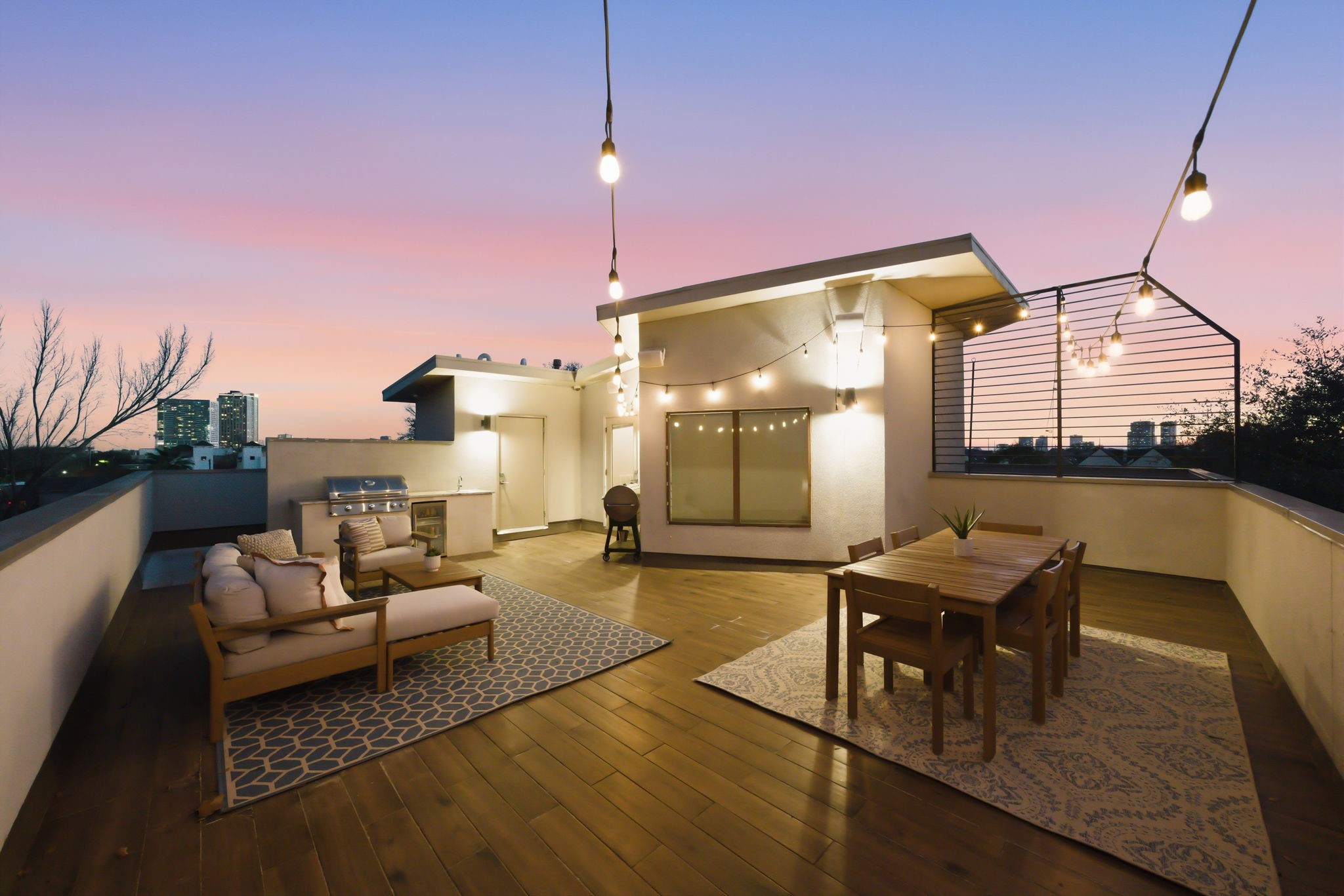 1405 Vermont Street, Unit A Houston, TX 77006 - Photo 1 of 46 Boasting panoramic Downtown views from 1405 Vermont Street #A, the expansive rooftop deck features a summer kitchen and designer finishes for premier Inner Loop entertaining. Contemporary styling meets luxury with a private seating area and outdoor dining space, all set atop this 3-bedroom Bradford Mews retreat.