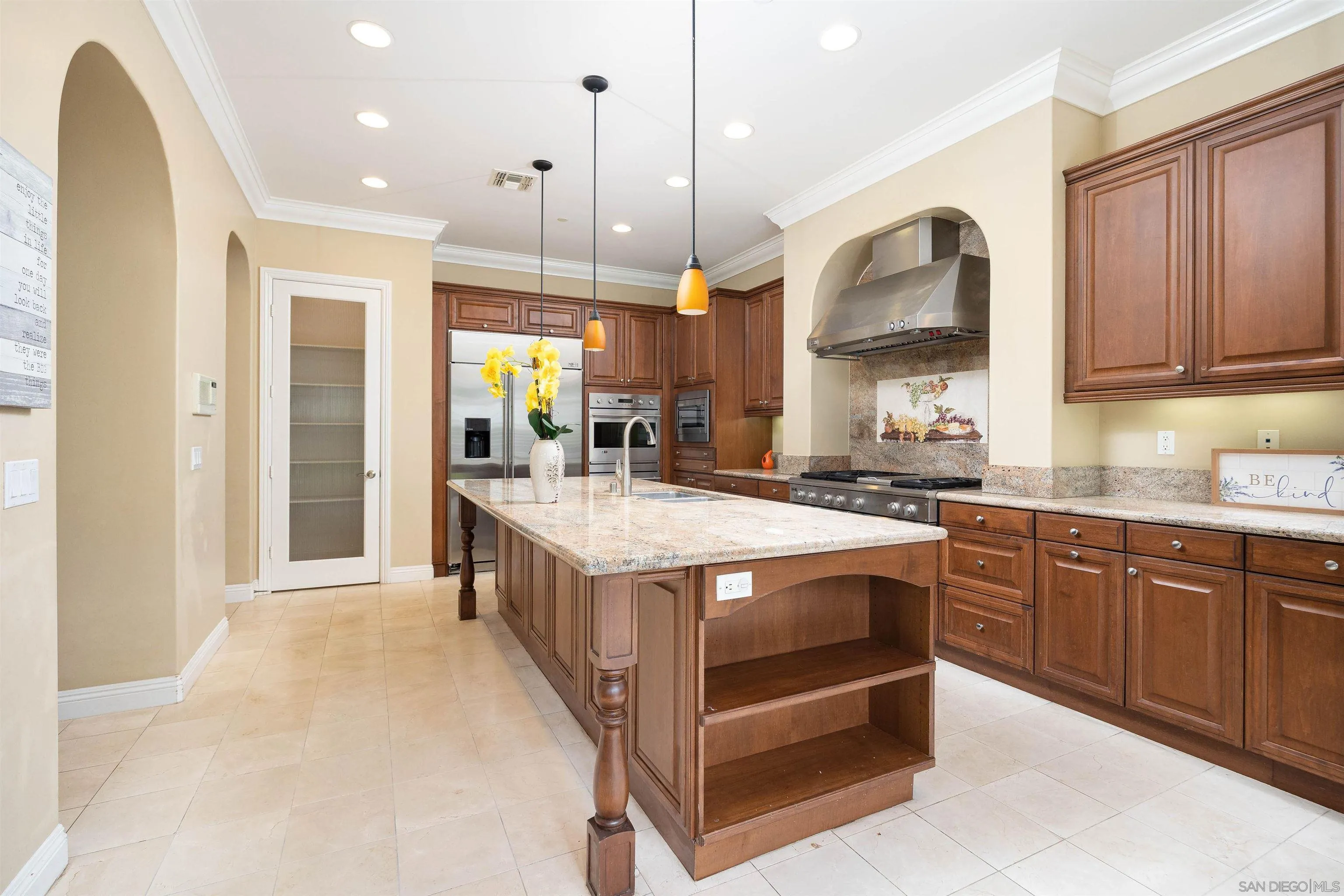 14803 Whispering Ridge Road San Diego, CA 92131 - Photo 11 of 41 a kitchen with stainless steel appliances granite countertop a stove and cabinets