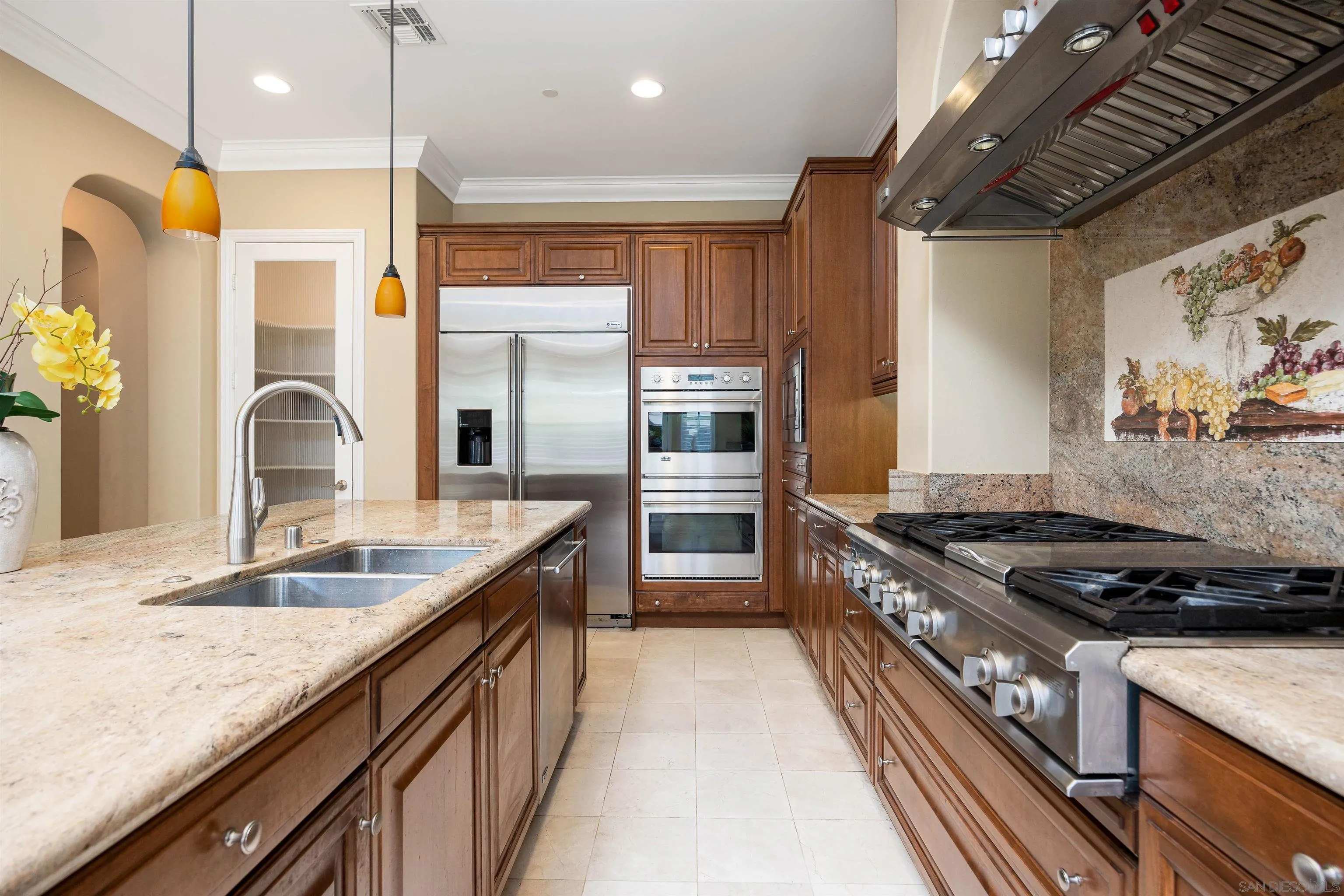 14803 Whispering Ridge Road San Diego, CA 92131 - Photo 12 of 41 a kitchen with stainless steel appliances granite countertop a sink stove and refrigerator