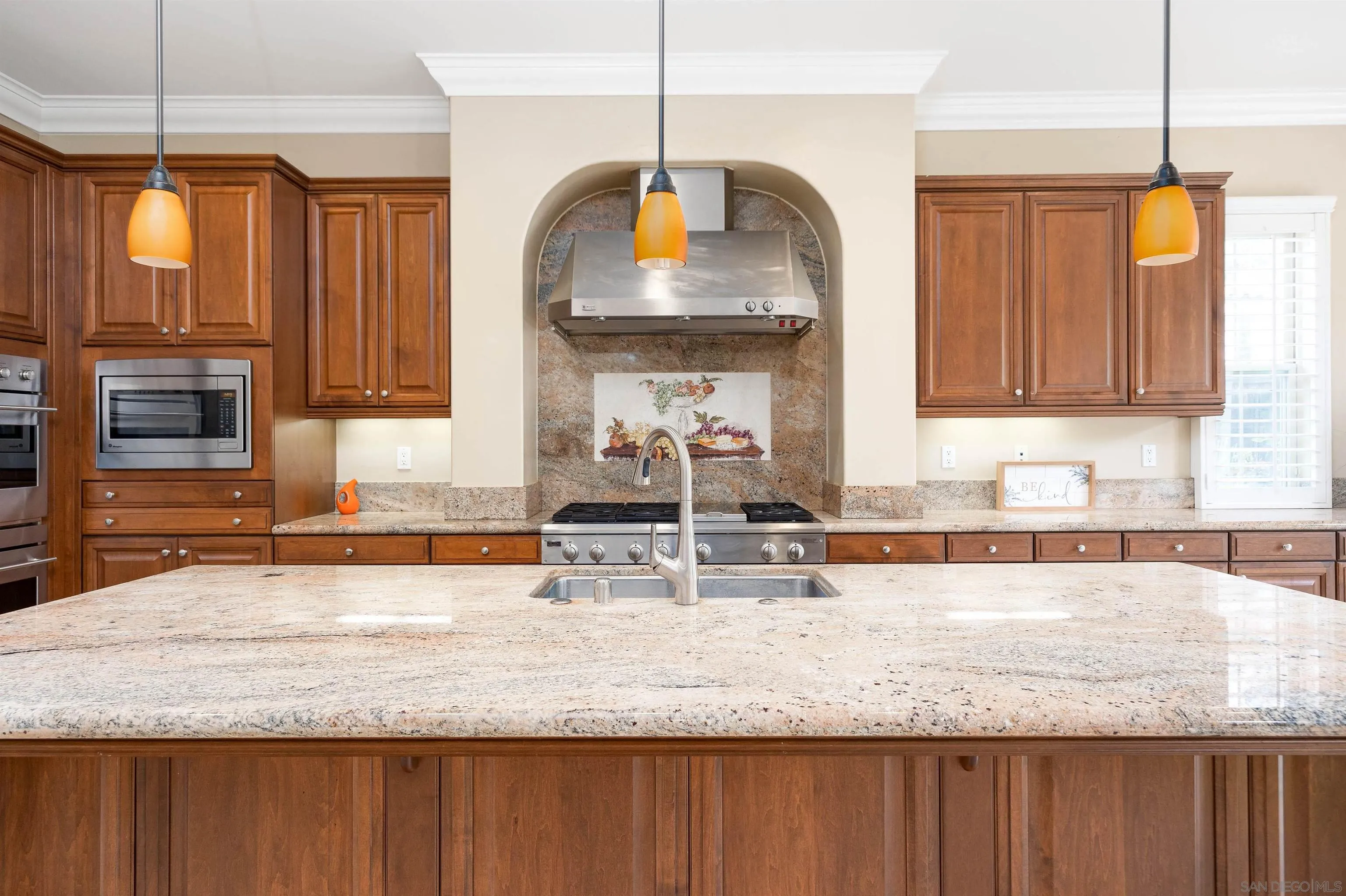 14803 Whispering Ridge Road San Diego, CA 92131 - Photo 13 of 41 a kitchen with granite countertop a sink a counter top space cabinets and stainless steel appliances