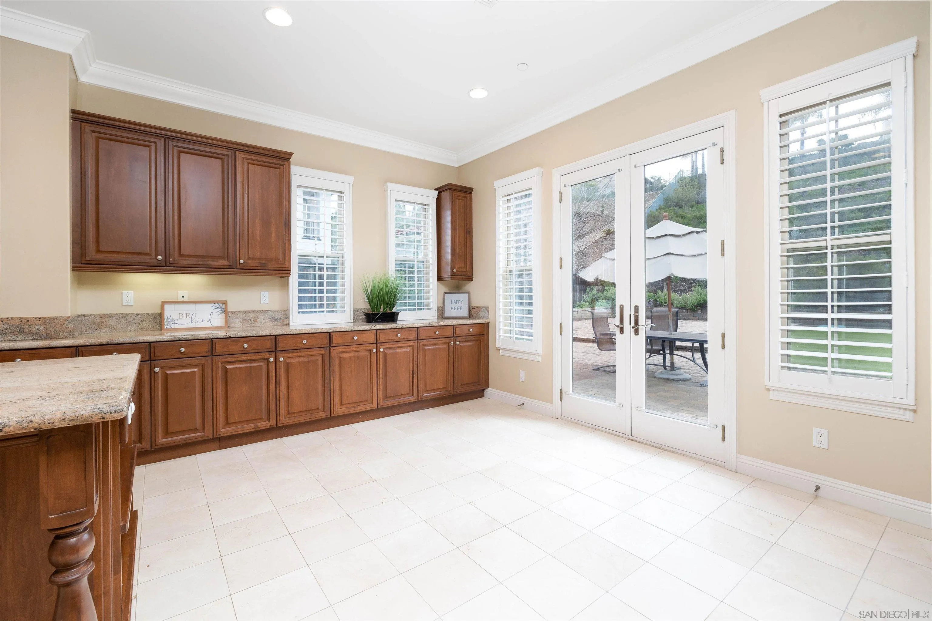 14803 Whispering Ridge Road San Diego, CA 92131 - Photo 14 of 41 a large kitchen with granite countertop a large window and a sink
