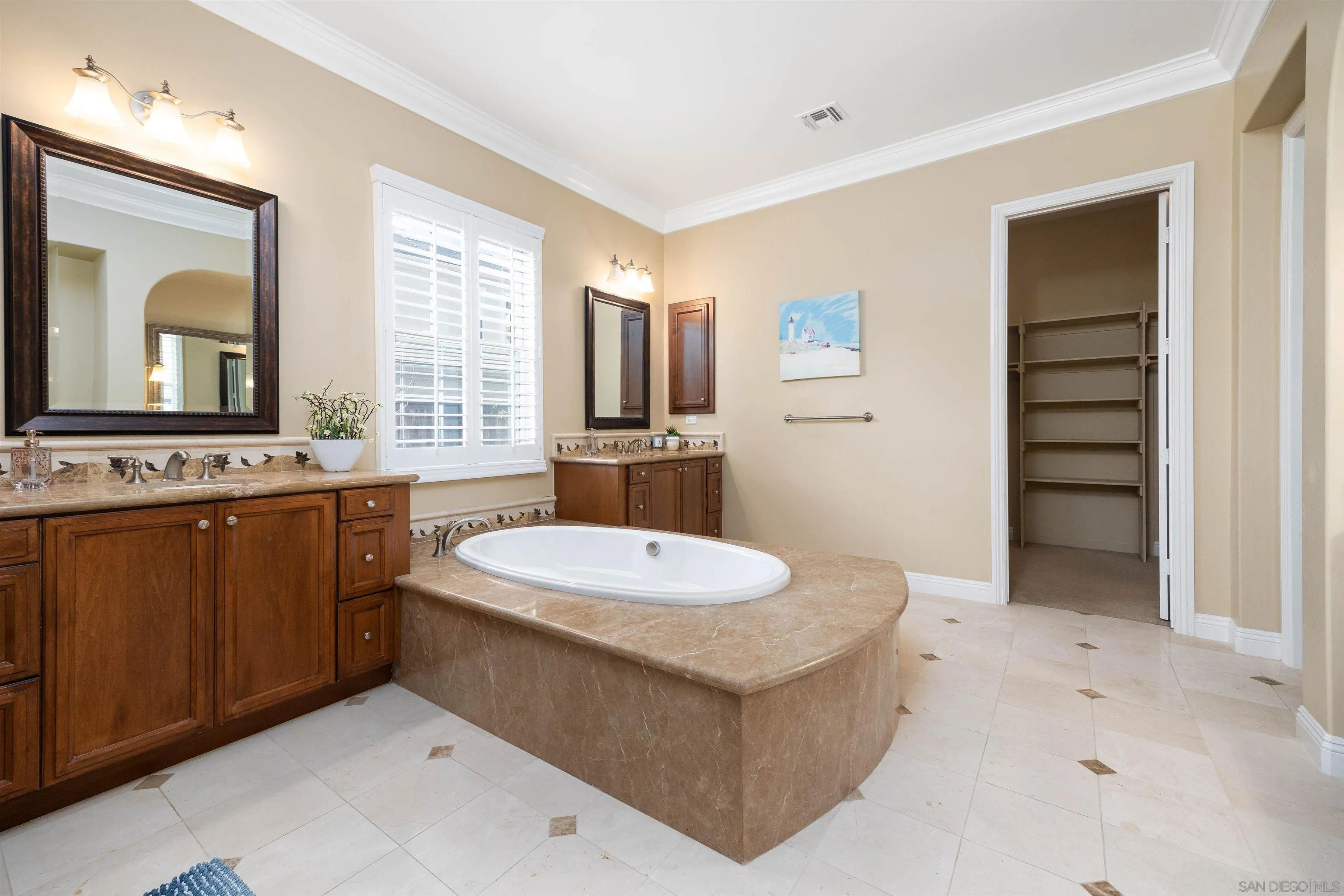 14803 Whispering Ridge Road San Diego, CA 92131 - Photo 17 of 41 a bathroom with a sink a toilet and mirror