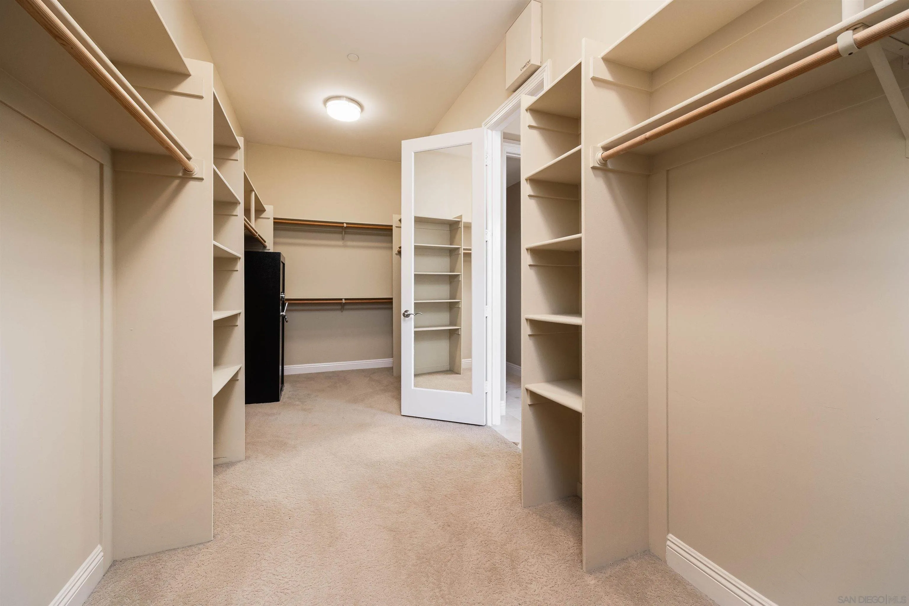 14803 Whispering Ridge Road San Diego, CA 92131 - Photo 19 of 41 a view of walk in closet with empty racks