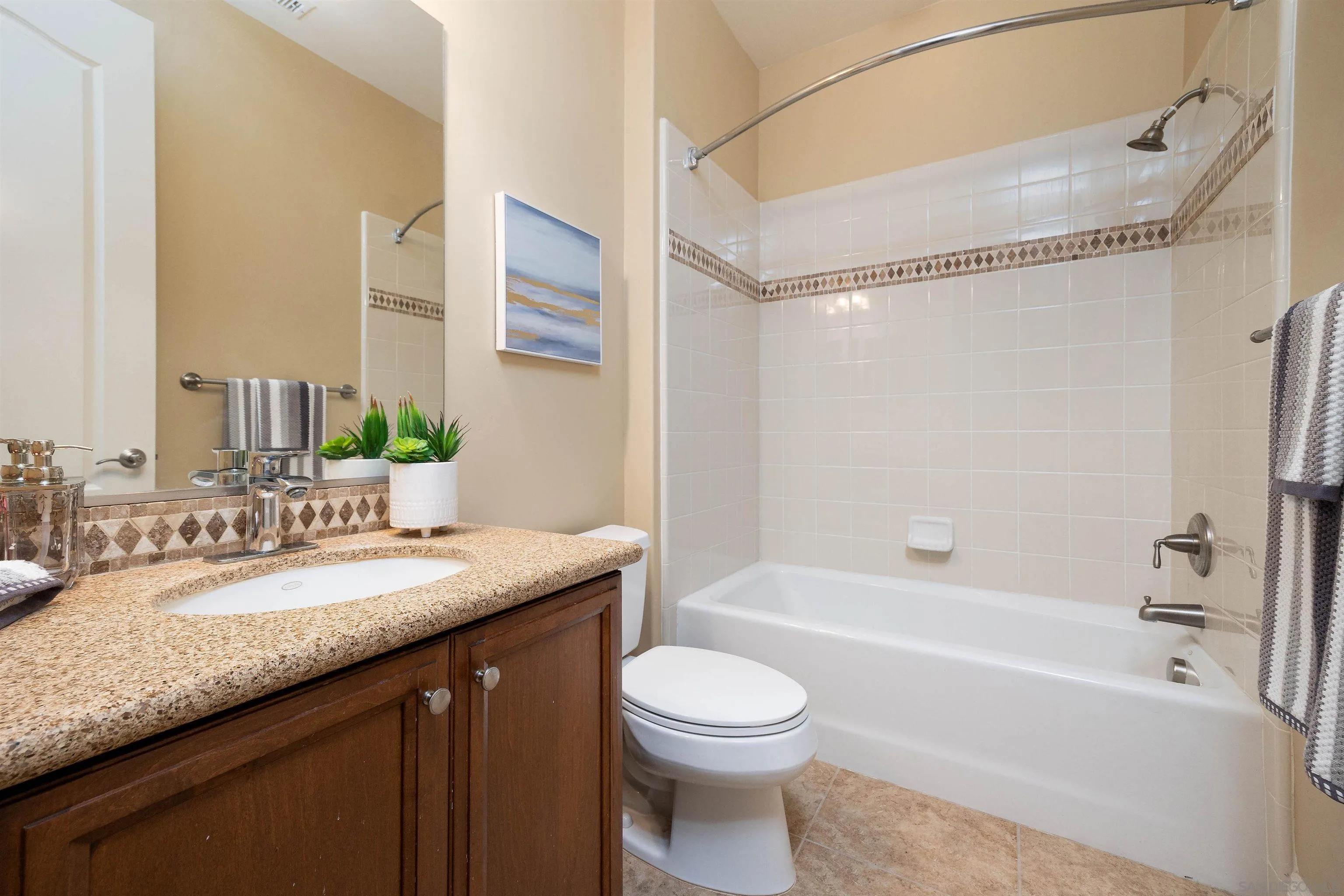 14803 Whispering Ridge Road San Diego, CA 92131 - Photo 22 of 41 a bathroom with a granite countertop sink toilet and shower