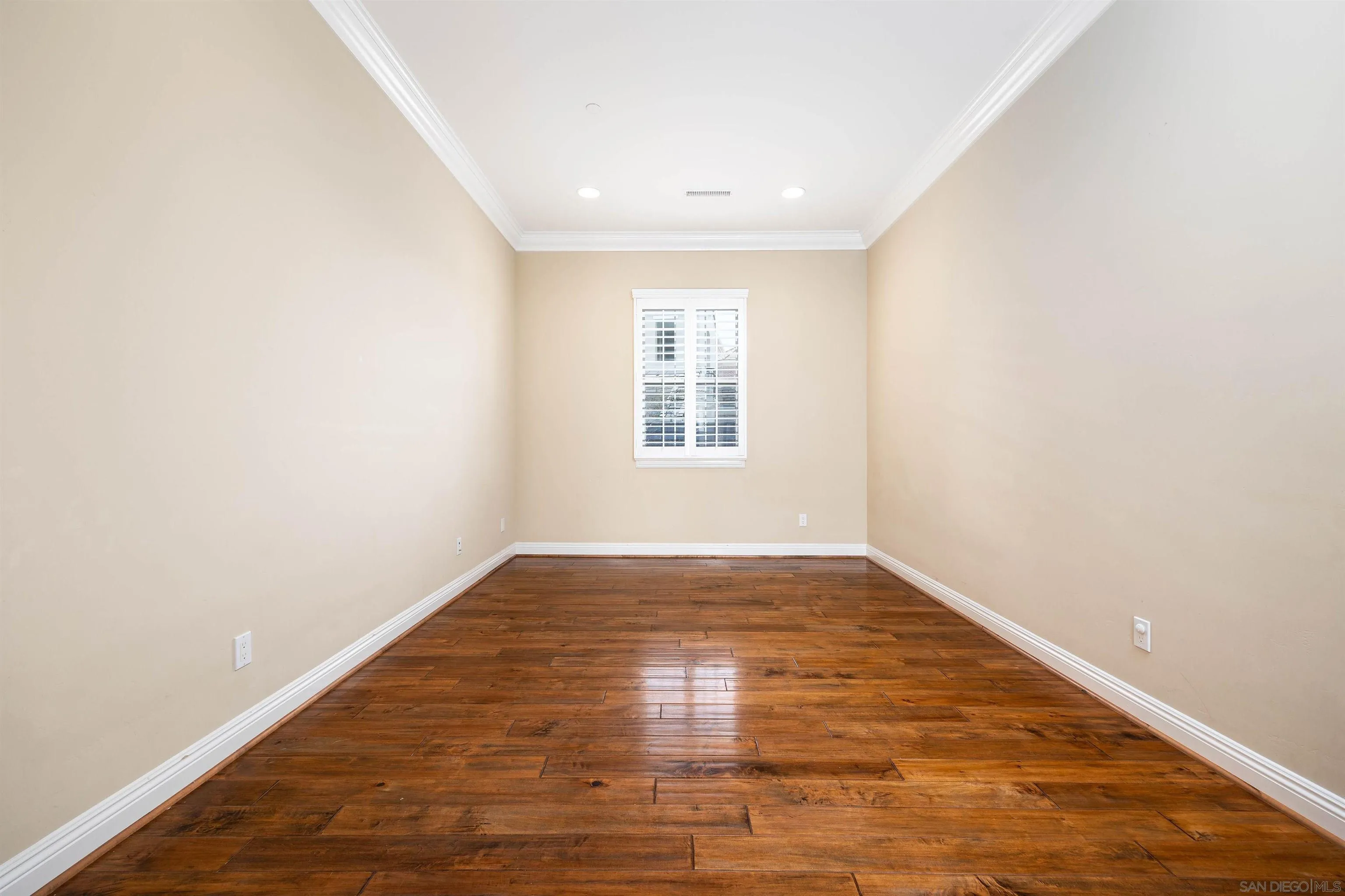 14803 Whispering Ridge Road San Diego, CA 92131 - Photo 23 of 41 an empty room with wooden floor and windows