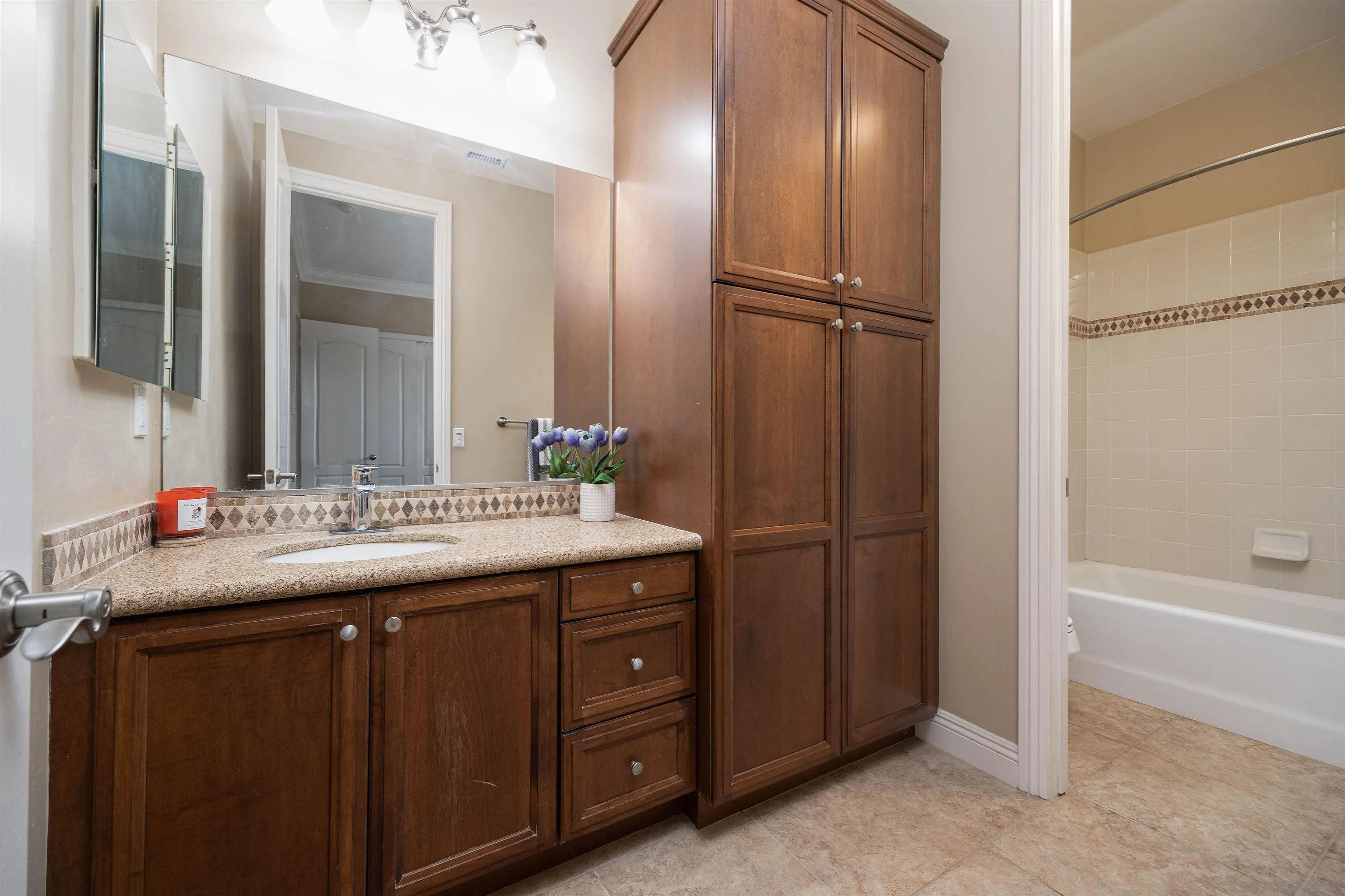 14803 Whispering Ridge Road San Diego, CA 92131 - Photo 25 of 41 a bathroom with a granite countertop sink and a mirror