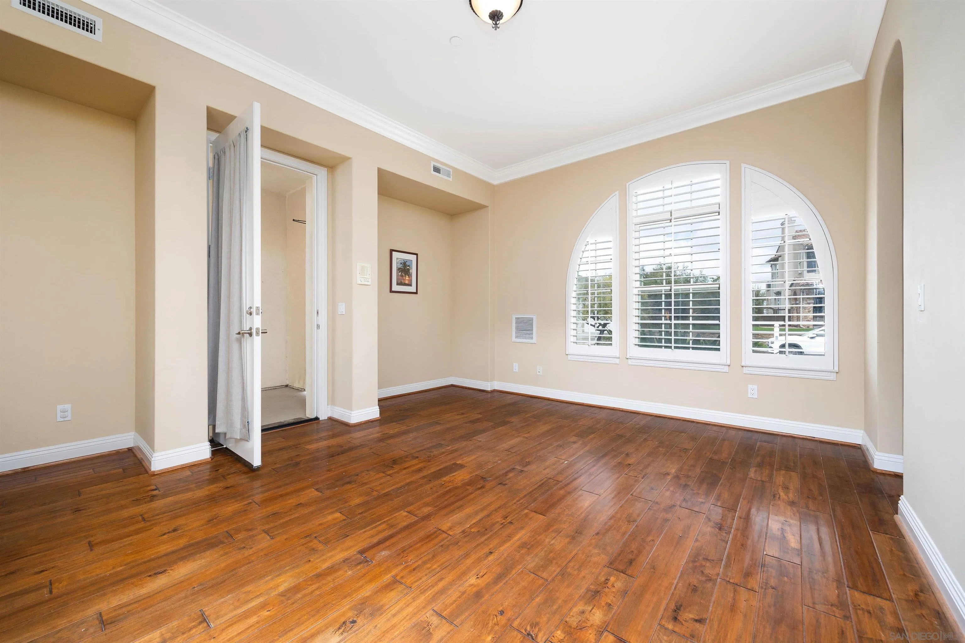 14803 Whispering Ridge Road San Diego, CA 92131 - Photo 28 of 41 a view of an empty room with wooden floor and a window