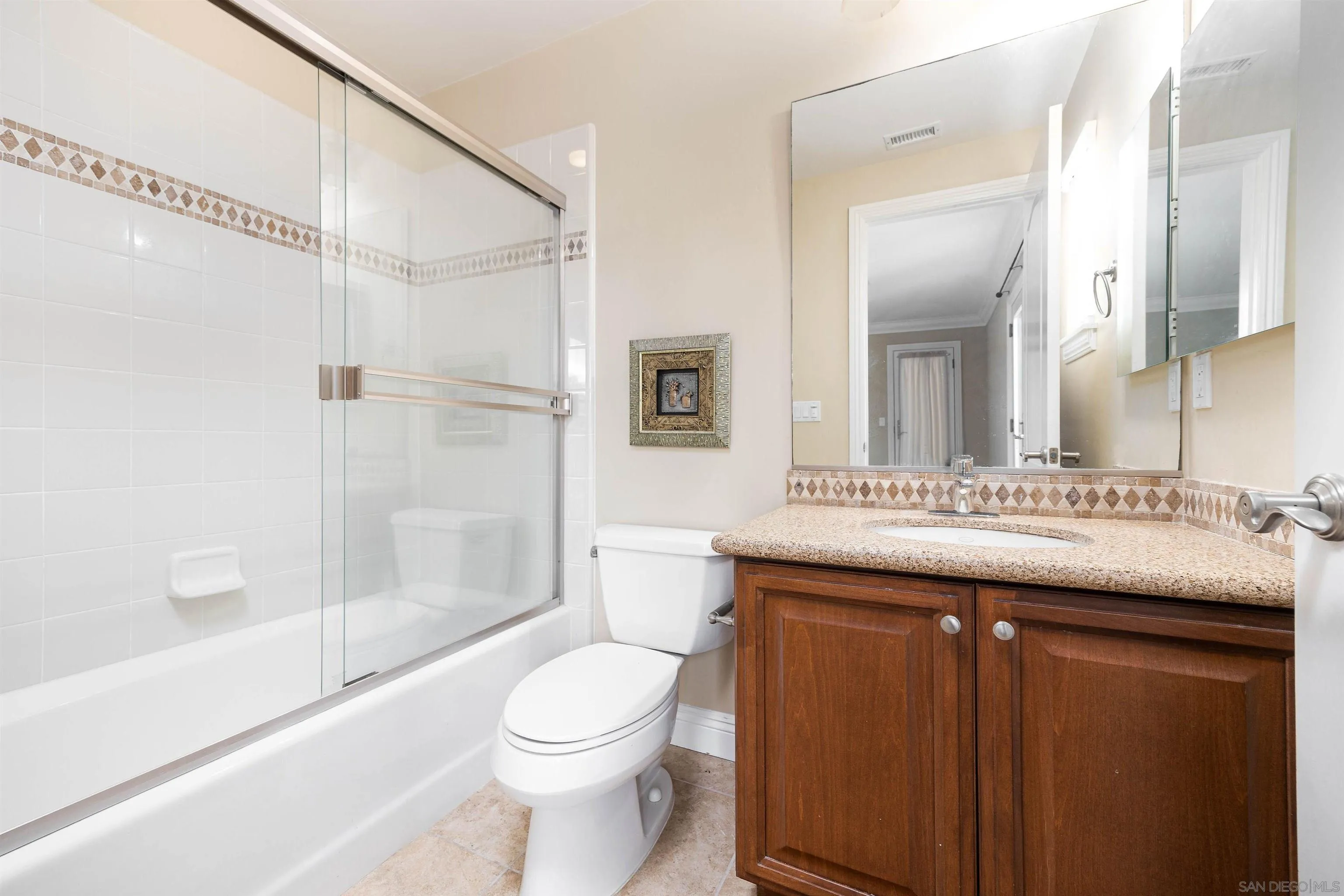 14803 Whispering Ridge Road San Diego, CA 92131 - Photo 33 of 41 a bathroom with a granite countertop sink toilet and shower