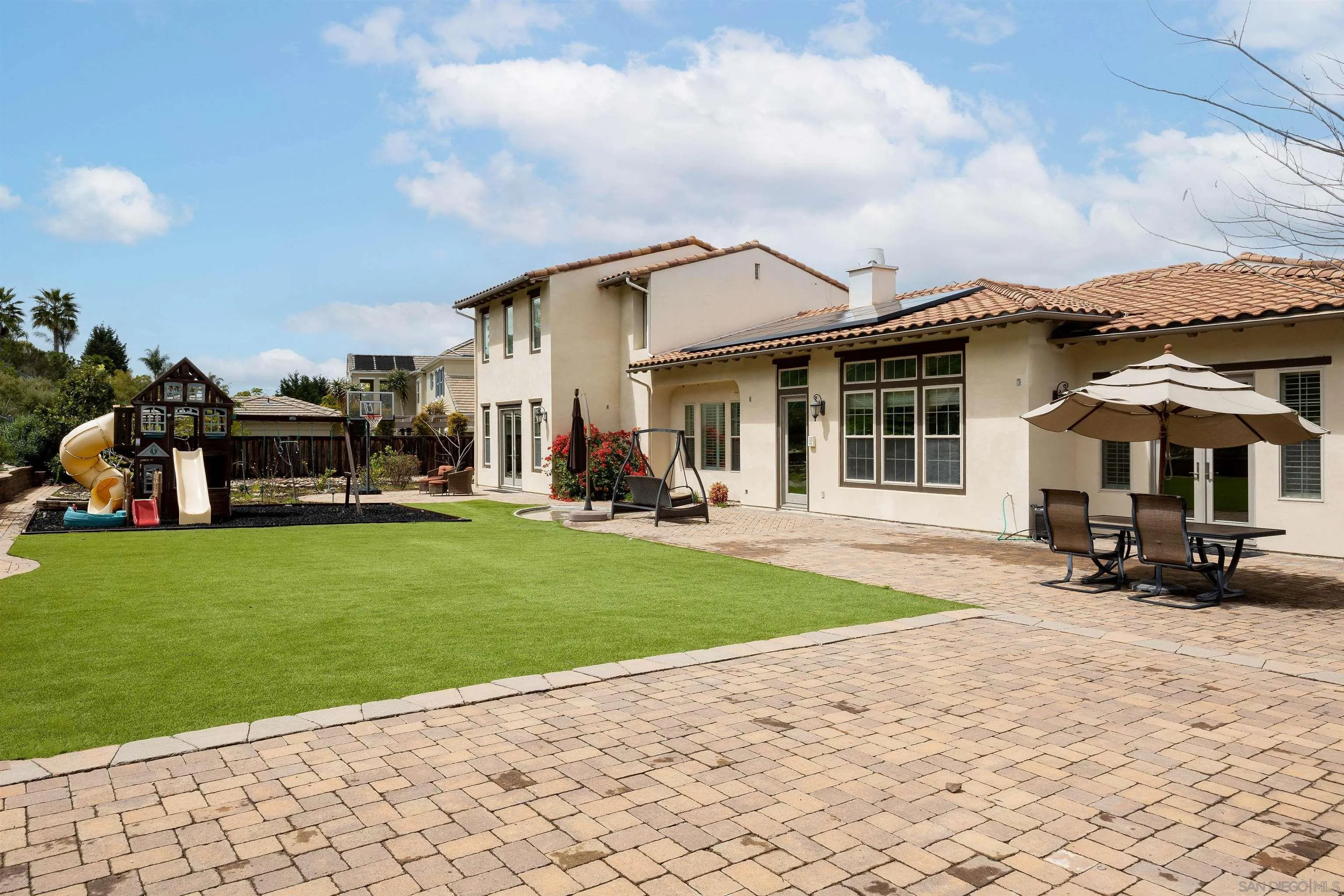 14803 Whispering Ridge Road San Diego, CA 92131 - Photo 36 of 41 a view of a house with backyard sitting area and garden