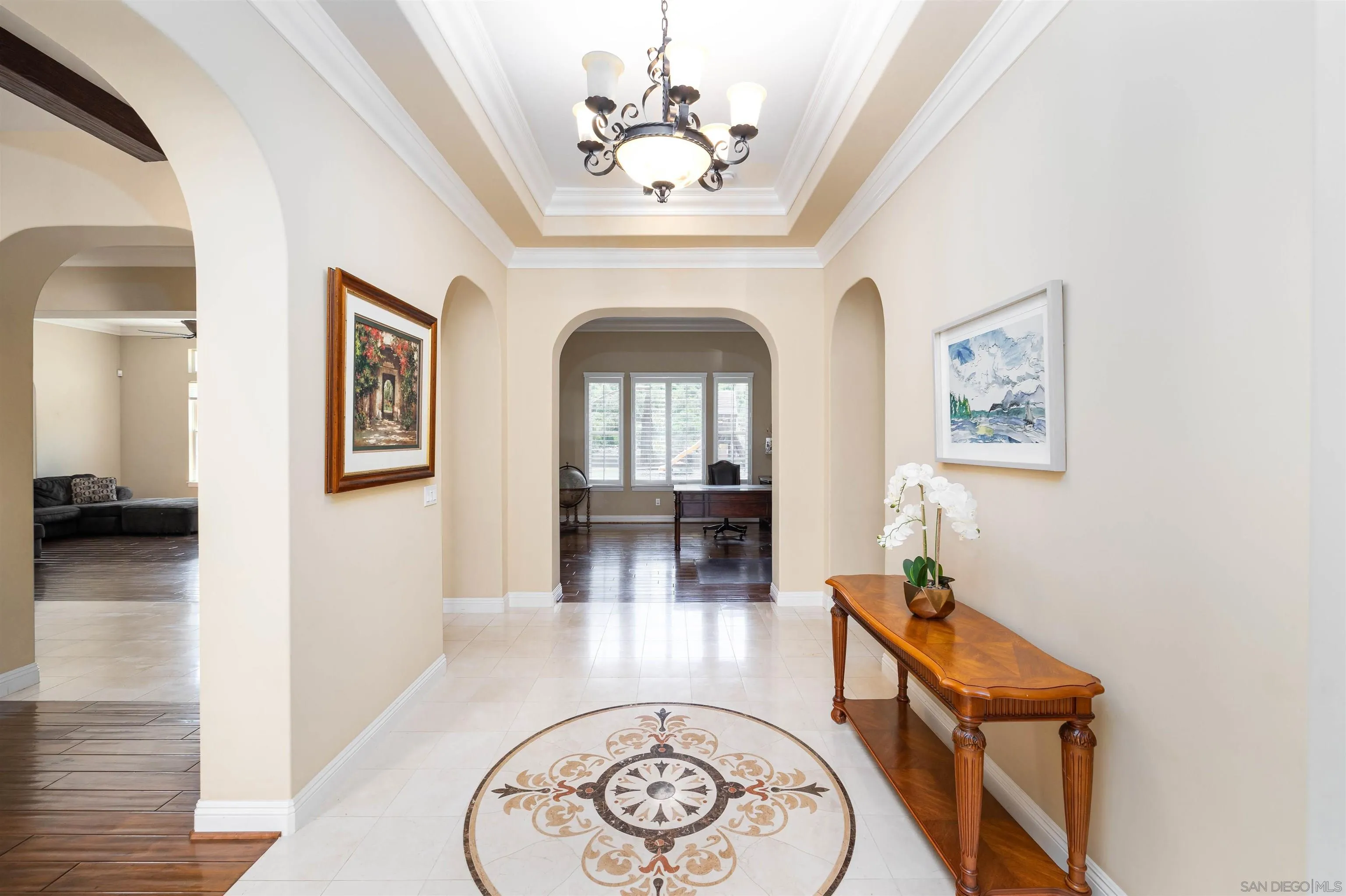 14803 Whispering Ridge Road San Diego, CA 92131 - Photo 4 of 41 a view of a hallway with entryway wooden floor and a chandelier