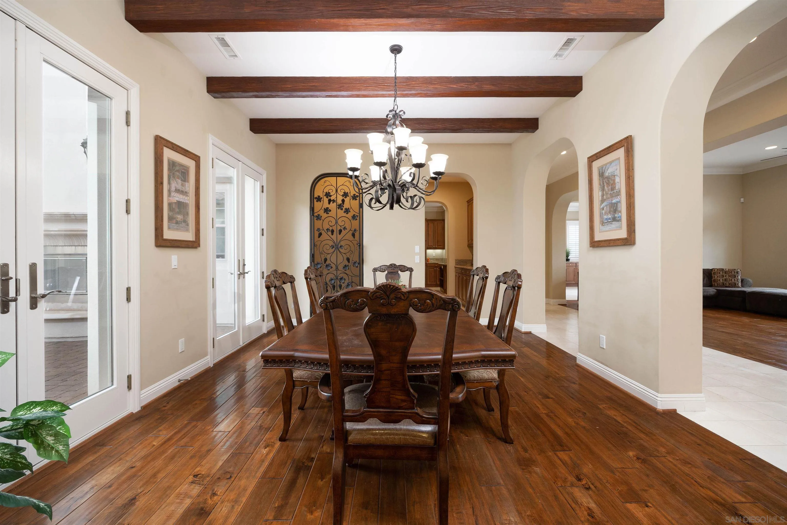 14803 Whispering Ridge Road San Diego, CA 92131 - Photo 6 of 41 a dining room with furniture a chandelier and wooden floor