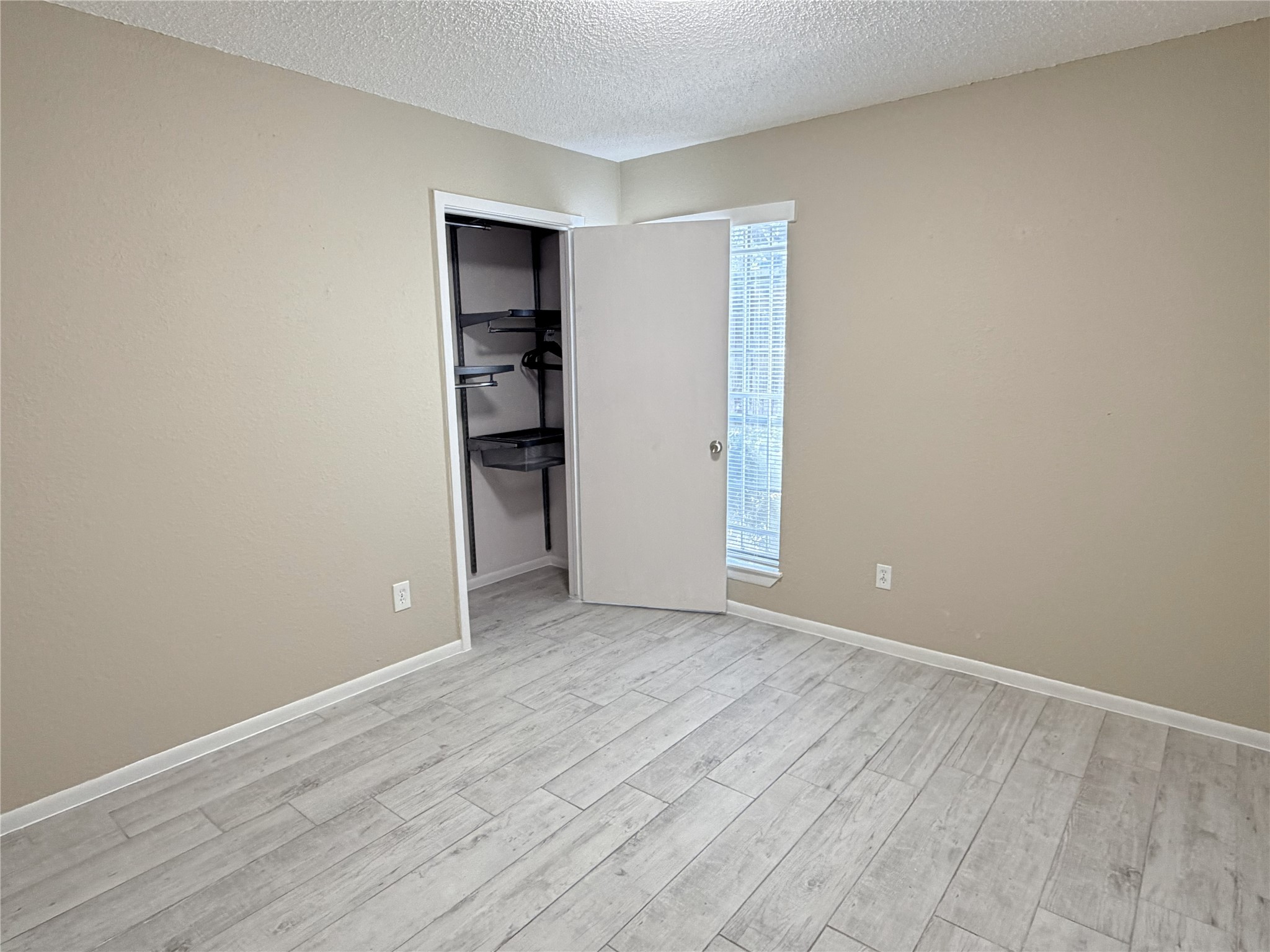 2800 Jeanetta Street, Unit 2813 Houston, TX 77063 - Photo 18 of 28 a view of empty room with wooden floor and cabinets