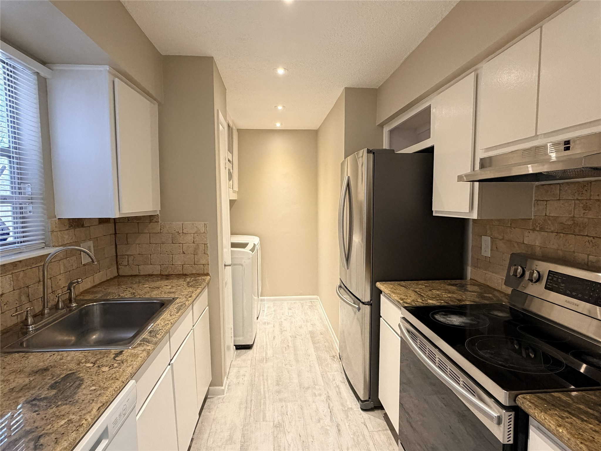 2800 Jeanetta Street, Unit 2813 Houston, TX 77063 - Photo 6 of 28 a kitchen that has a sink cabinets counter space and stainless steel appliances