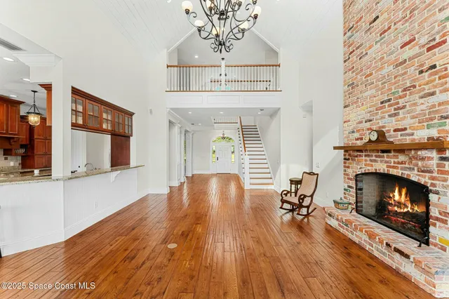 a living room with furniture fireplace and a large window