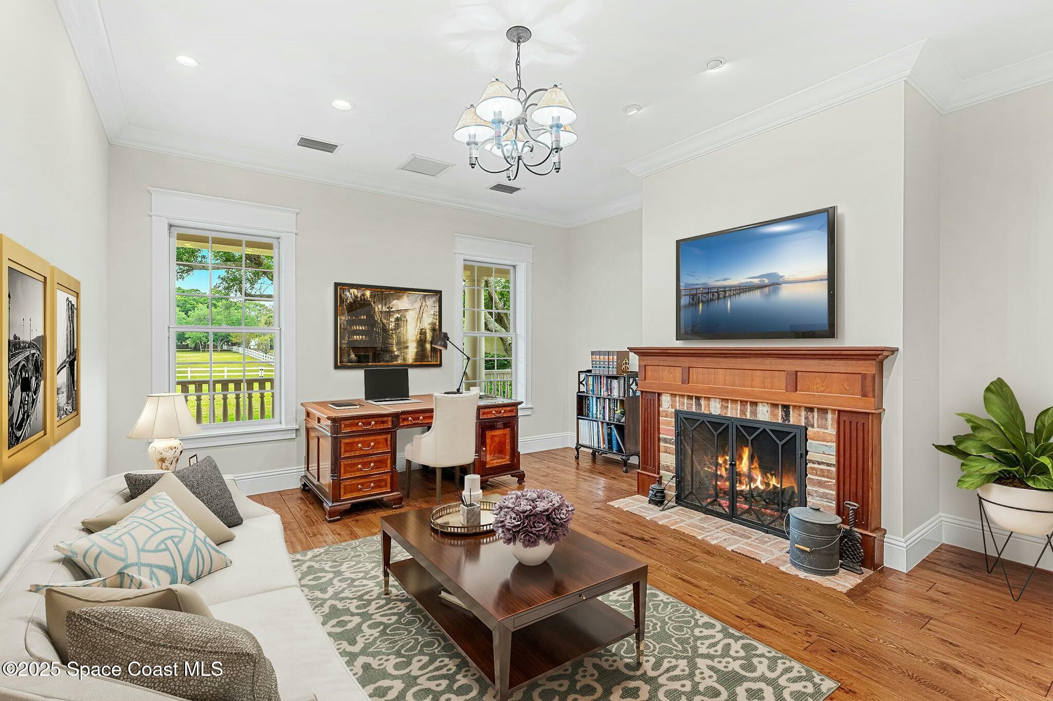 9490 South Tropical Trail Merritt Island, FL 32952 - Photo 20 of 63 a living room with furniture a window and a fireplace