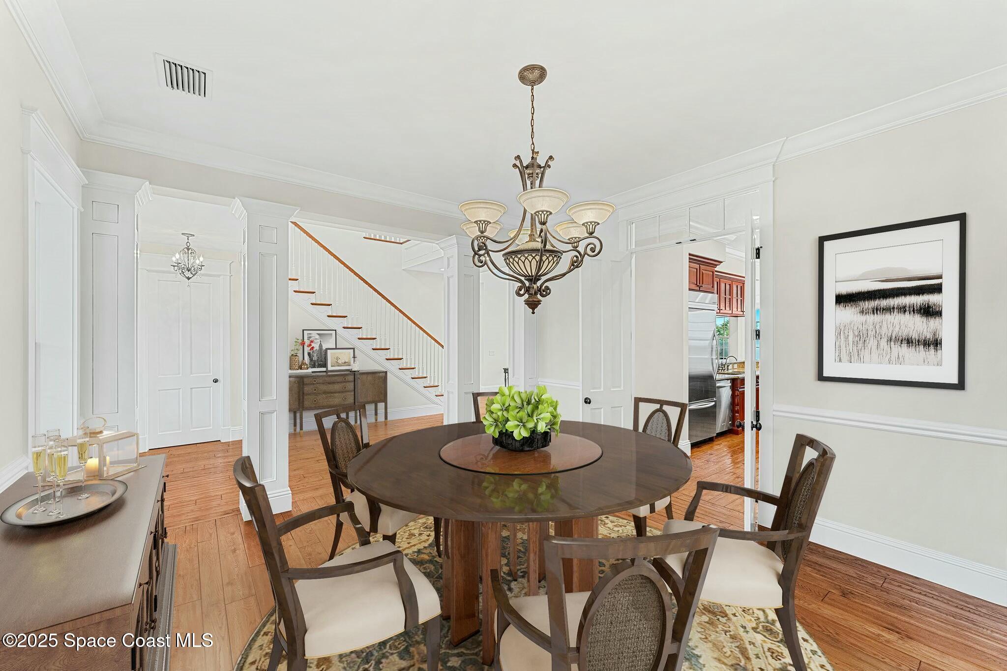 9490 South Tropical Trail Merritt Island, FL 32952 - Photo 22 of 63 a view of a dining room with furniture wooden floor and chandelier