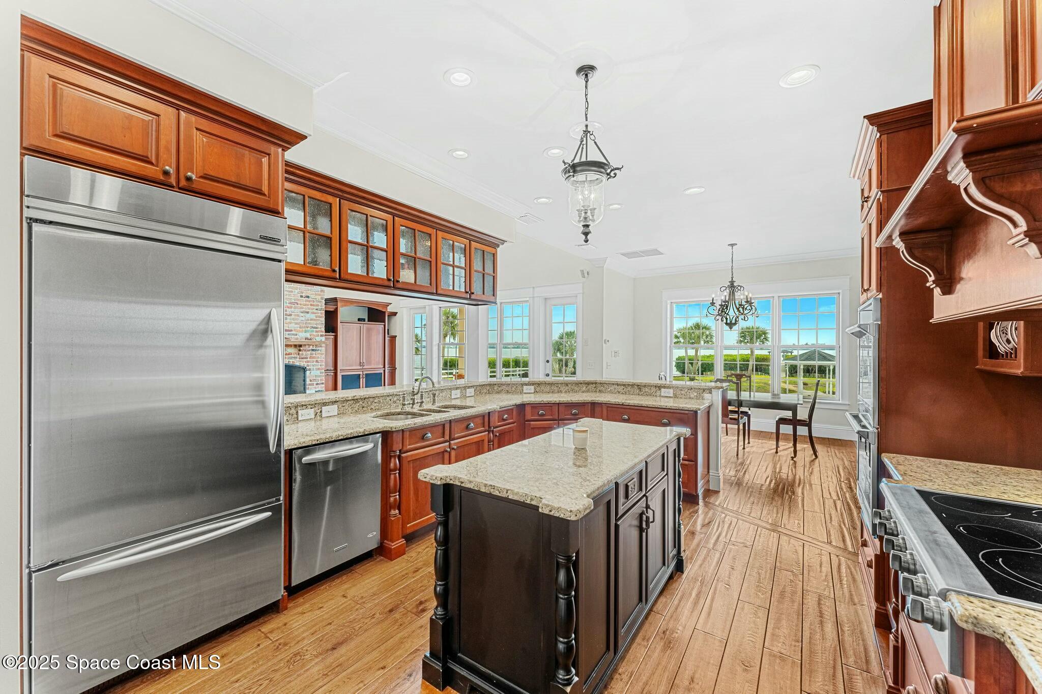 9490 South Tropical Trail Merritt Island, FL 32952 - Photo 26 of 63 a kitchen with stainless steel appliances granite countertop a stove and a refrigerator