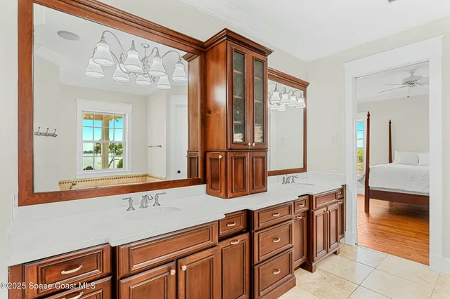 a view of staircase with railing and chandelier