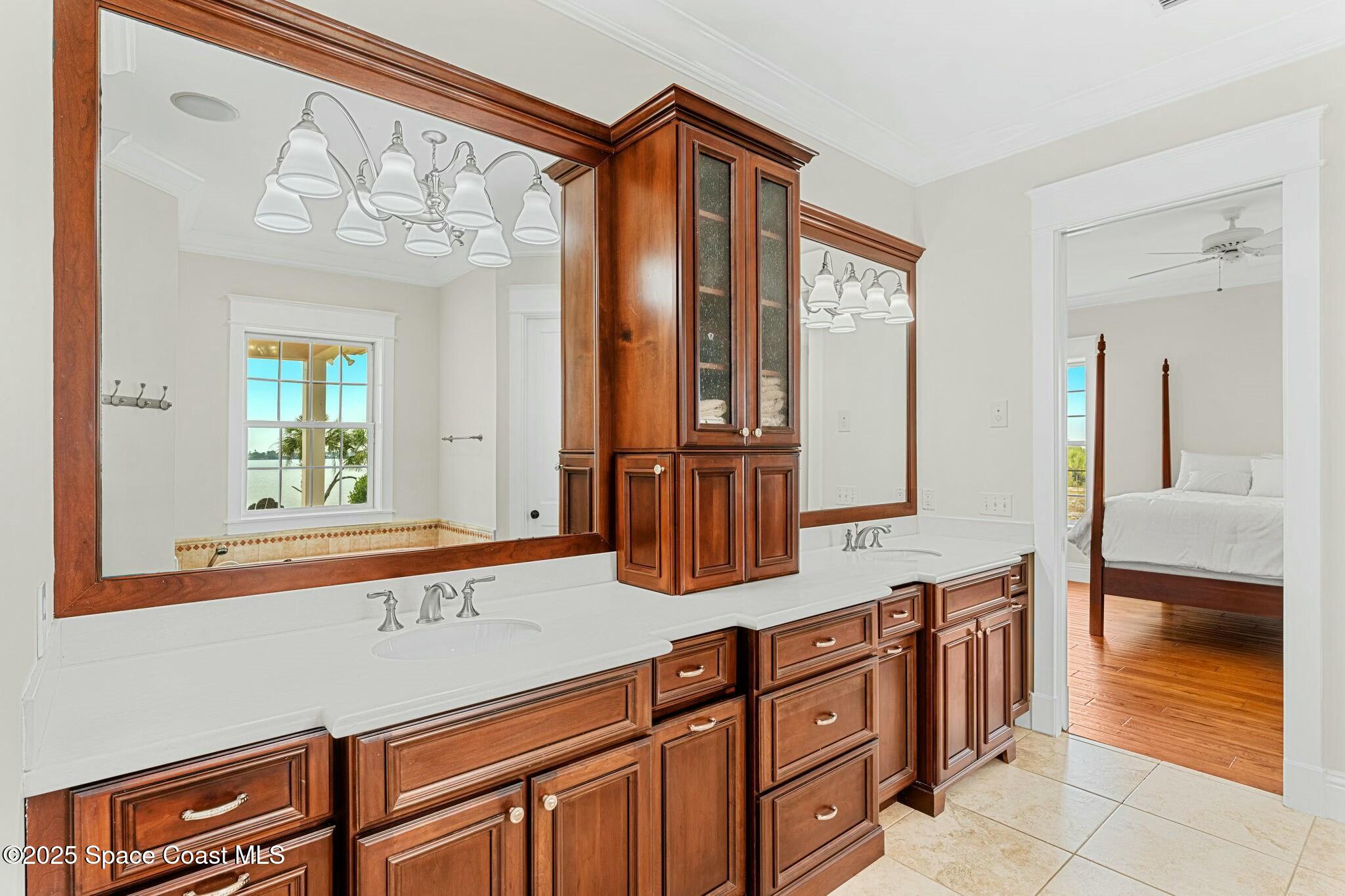 9490 South Tropical Trail Merritt Island, FL 32952 - Photo 27 of 63 a bathroom with a sink a mirror and a shower
