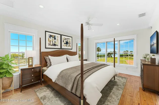 a view of a room with a ceiling fan and carpet