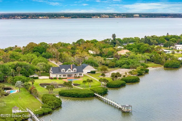 a view of a lake with lawn chairs