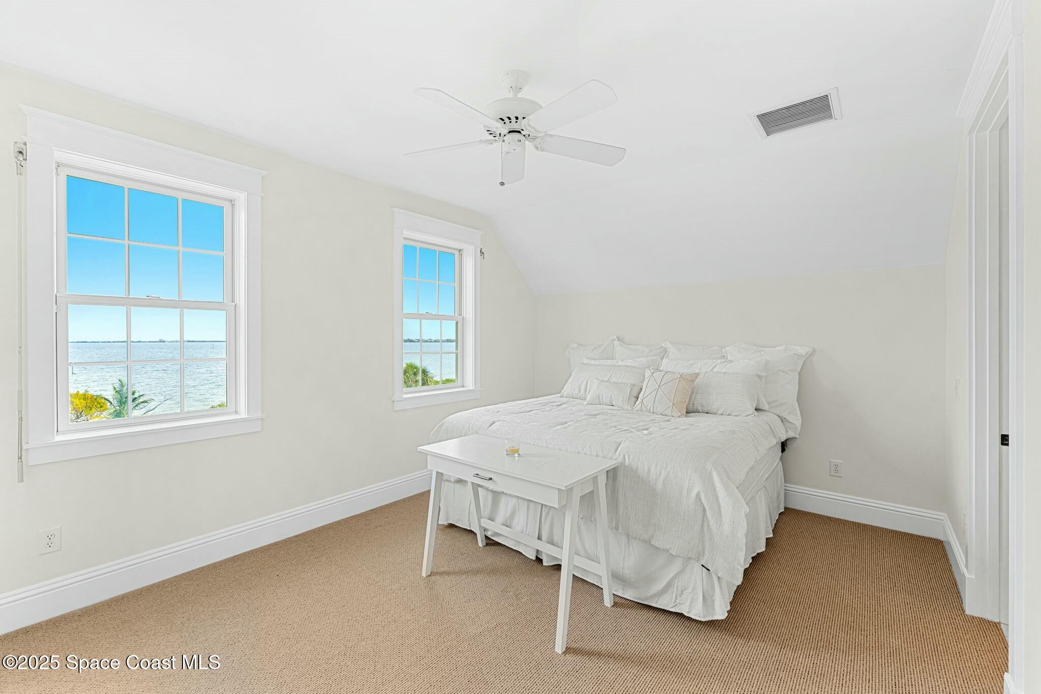 9490 South Tropical Trail Merritt Island, FL 32952 - Photo 36 of 63 a bedroom with a bed and a window