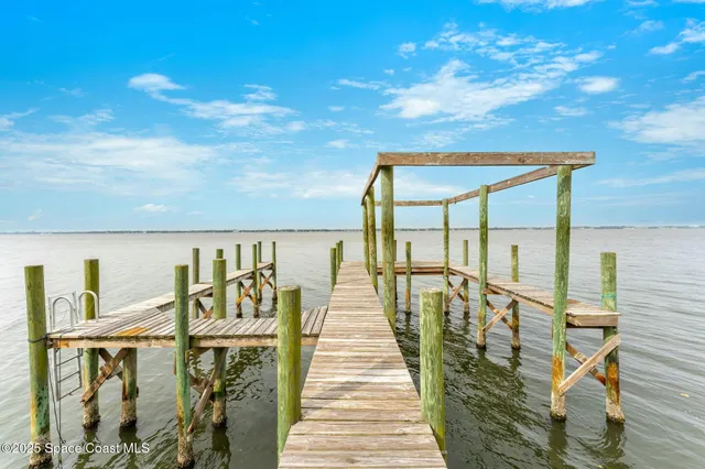 a view of a yard with wooden fence