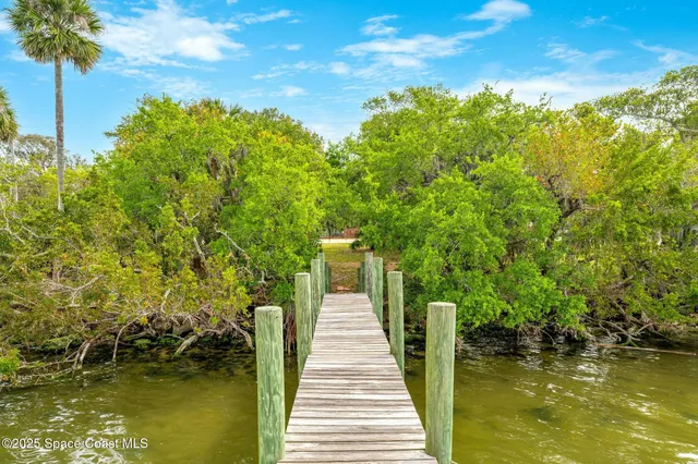 a view of balcony with wooden floor and fence