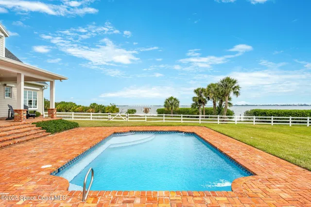 a view of a swimming pool and an outdoor seating