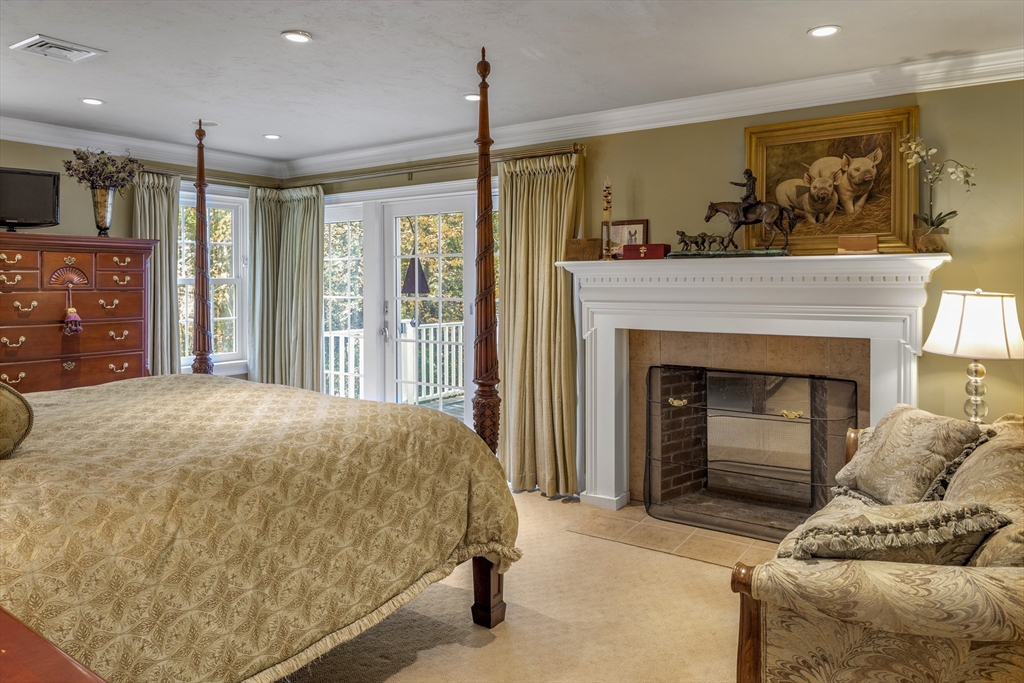 98 Valley Road Boxford, MA 01921 - Photo 18 of 40 a bed room with a bed and a fireplace