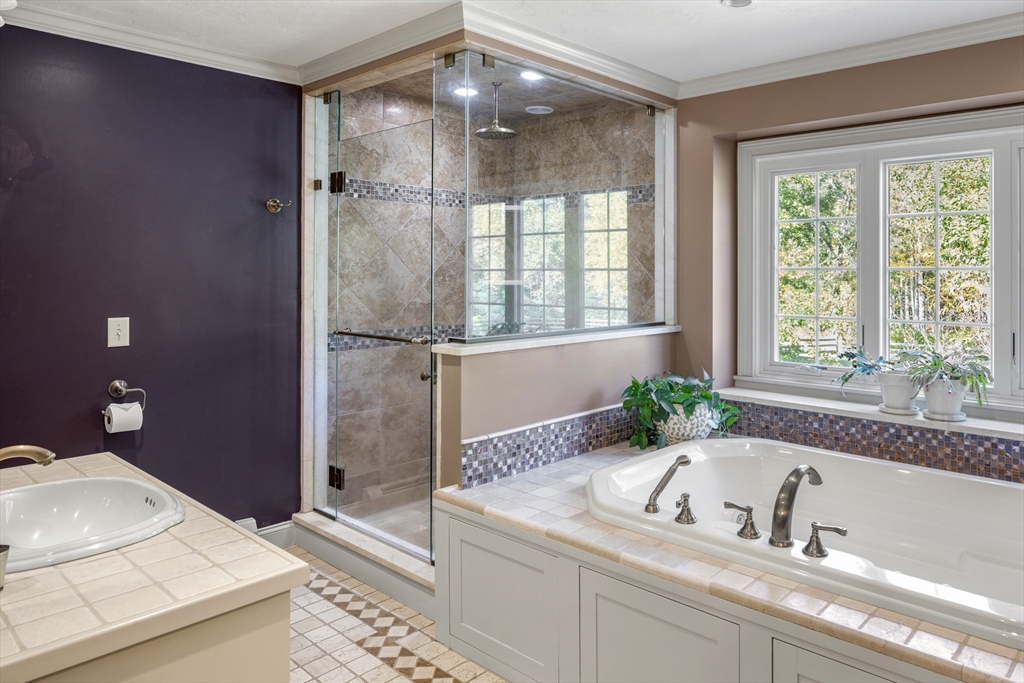98 Valley Road Boxford, MA 01921 - Photo 19 of 40 a bathroom with a granite countertop tub a sink and a large window