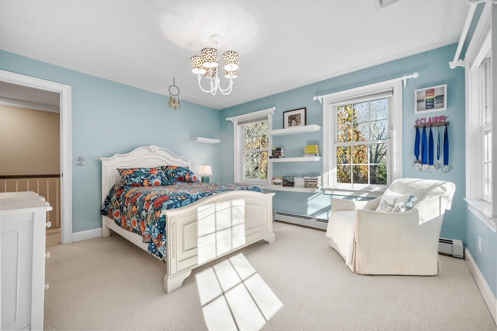98 Valley Road Boxford, MA 01921 - Photo 23 of 40 a bedroom with a large bed and a chandelier
